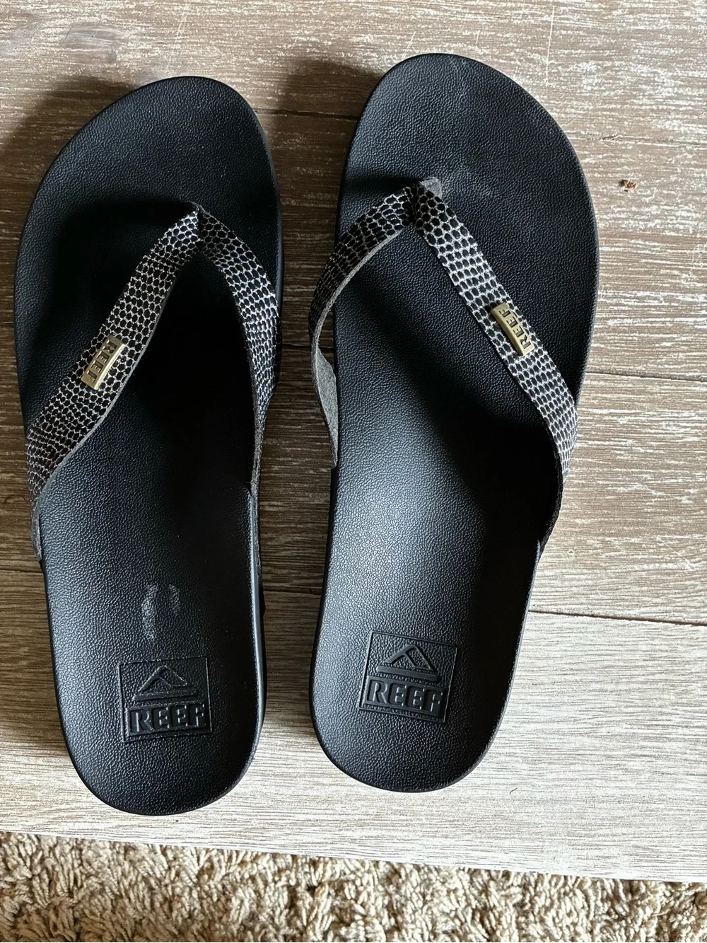 Reef Black Cushion Court Flip Flops with Snakeskin-Pattern Straps and Gold Logo